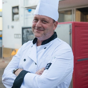 Smiling chef with folded arms